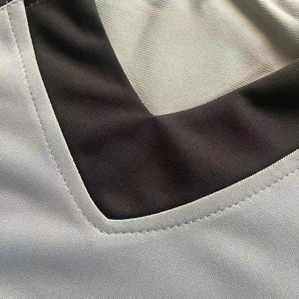 Detailed view of the rib-knit collar and neck stitching on the Peanuts Wildcats football jersey #20