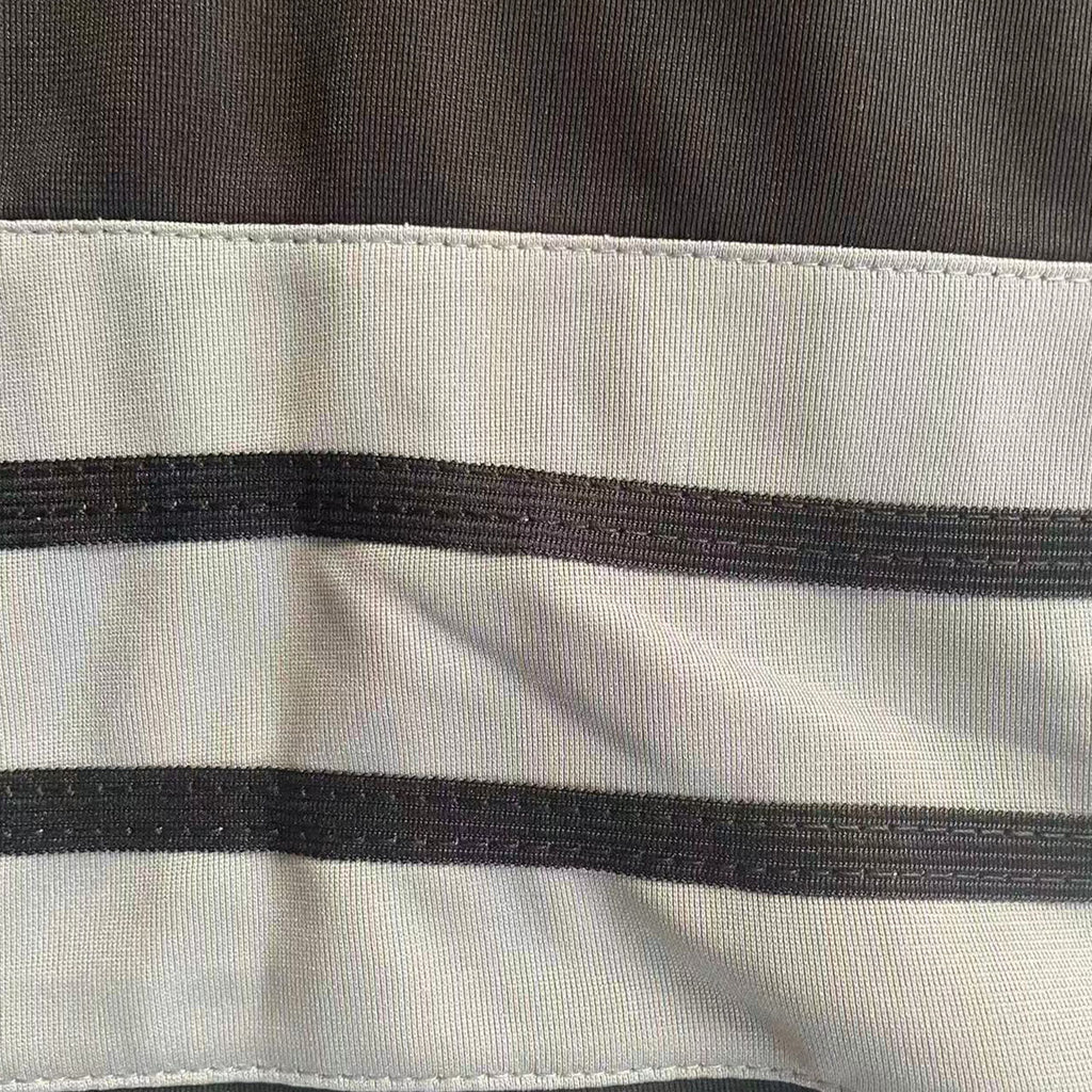 Magnified view of the classic striped knit ribbing on the sleeve of the Peanuts Wildcats football jersey