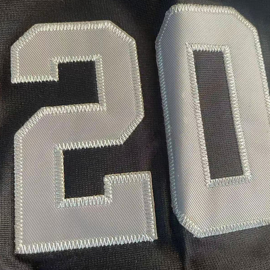 Close-up of number 20 tackle twill embroidery on the sleeve of the Peanuts Wildcats jersey