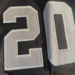 Close-up of number 20 tackle twill embroidery on the sleeve of the Peanuts Wildcats jersey