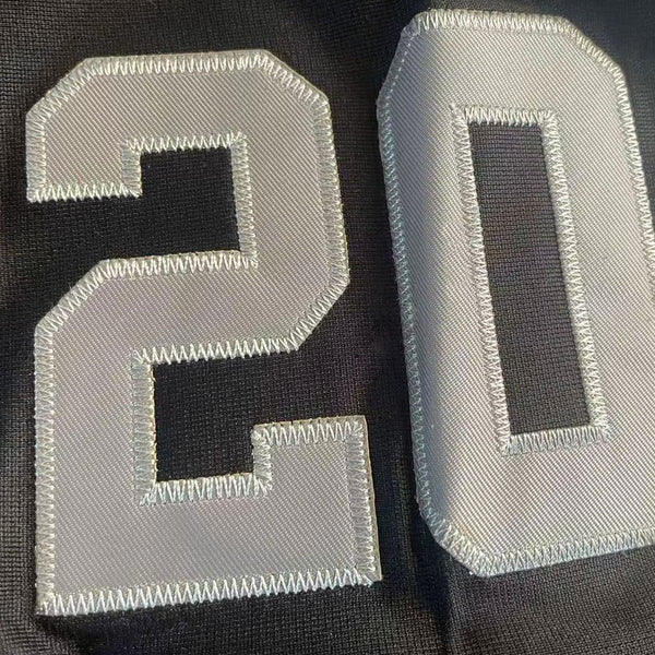 Close-up of number 20 tackle twill embroidery on the sleeve of the Peanuts Wildcats jersey