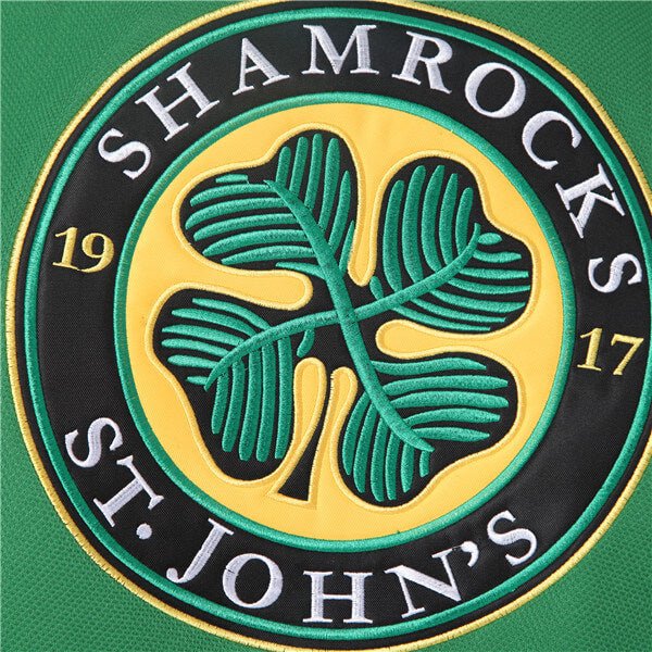 Detailed Close-up of Stitched Shamrocks Team Logo on Green Hockey Jersey