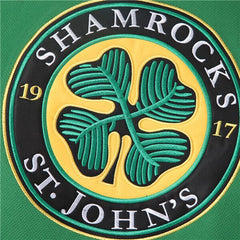 Detailed Close-up of Stitched Shamrocks Team Logo on Green Hockey Jersey